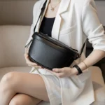 sac banane femme chic en cuir grainé noir ciré détails porté dans les mains