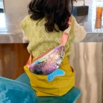 sac banane sirène rose porté en bandoulière dans le dos par une fille