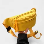 sac-banane-jaune-vif-jonquille-narcisse sac banane jaune vif porté dans une main