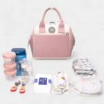 sac banane langer rose avec toutes les affaires de bébé
