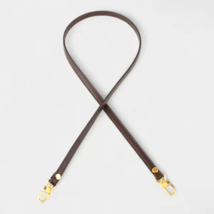 Bandoulière Cuir Fine marron avec mousquetons et rivets dorés, finition teinture soignée sur les tranches.