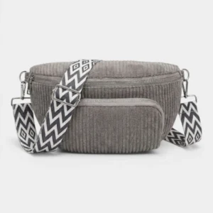 Sac banane velours côtelé gris foncé posé de face, avec sangle jacquard à motif chevron contrasté