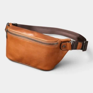 Sac banane cuir marron clair posé en trois quarts, avec sangle réglable et fermeture métallique apparente