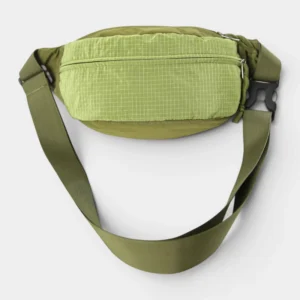 Sac banane en nylon ripstop vert kaki clair, posé de face avec une sangle à clip plastique