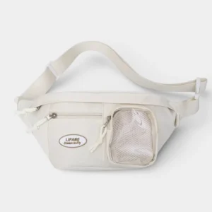 Sac banane femme en nylon blanc crème posé de face, avec une poche avant en mesh transparent