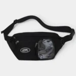 Sac banane noir en nylon posé à plat de face, avec une poche transparente zippée sur le devant
