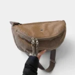 Grand Sac Banane Femme Velours Côtelé Demi-Lune Sac banane velours côtelé demi-lune beige taupe tenu à la main, présenté de face avec sa double fermeture éclair