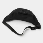 Grand Sac Banane XXL Streetwear Sac banane XXL en nylon noir au style streetwear, vue arrière posé sur fond neutre avec sangle à boucle plastique