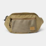 Grand Sac Banane XXL Streetwear Grand sac banane XXL streetwear en nylon beige kaki, posé de face avec une poche avant en mesh texturé