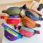 Sac banane enfant en nylon présenté dans ses six coloris, disposés à plat et vus de dessus.