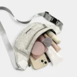 Sac Banane Imprimé Japonais Feuilles Argentées Sac banane demi-lune blanc ouvert sur sa poche principale avec un smartphone et du maquillage
