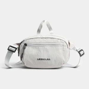 Sac banane en nylon froissé gris clair posé de face avec sa poignée et sa sangle réglable à boucles noires