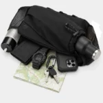 Sac banane en nylon ripstop noir avec gourde dans le fourreau à cordon et smartphone posé devant