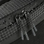 Sac Banane Trekking Imperméable Accrochable Sac banane ripstop noir en gros plan avec gouttes d'eau sur le tissu et tirettes en cordon tressé