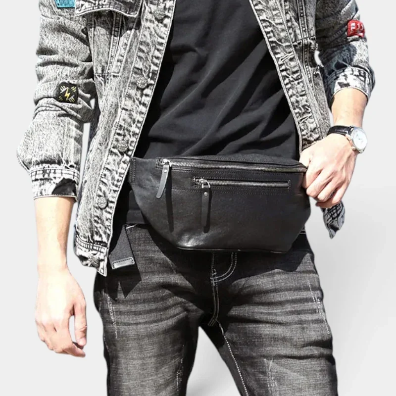 Grand sac banane cuir noir porté à la taille par un homme, vue de face au style décontracté