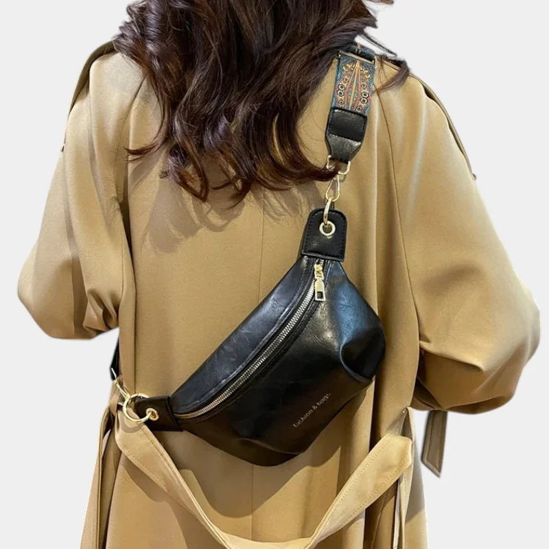 Sac banane en cuir noir porté dans le dos par une femme au style chic, avec une sangle ethnique colorée